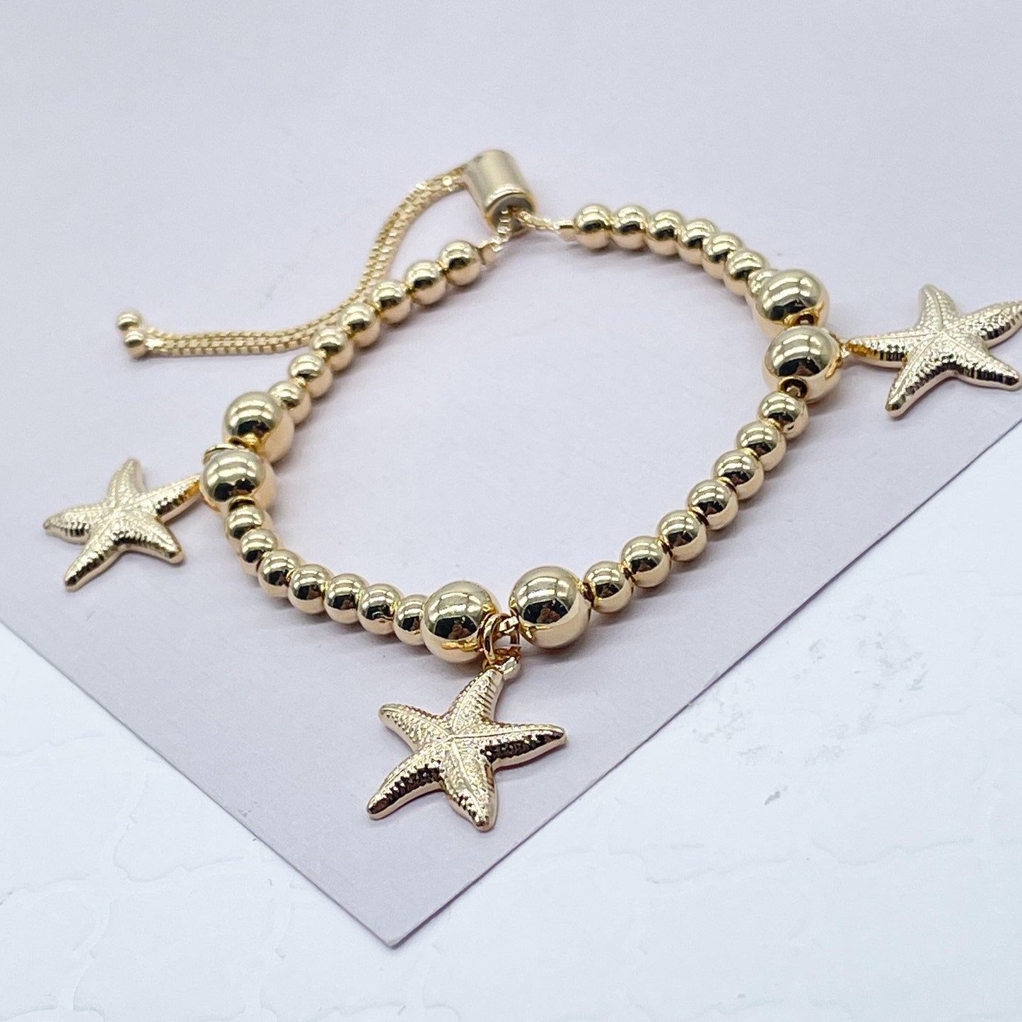 18k Gold Layered 4mm Beaded Bracelet With Starfish Charms In An Sophisticated