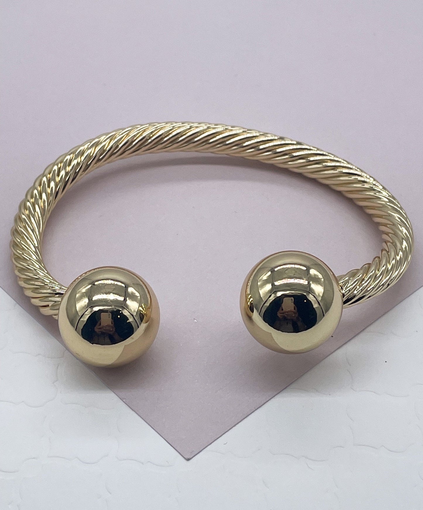 18k Gold Layered Twisted Bangle Featuring Two Solid Balls On Top Wholesale