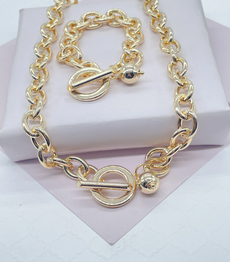 18k Gold Layered Oval Link Necklace And Bracelet Set Featuring Toggle Closure And Hanging Ball