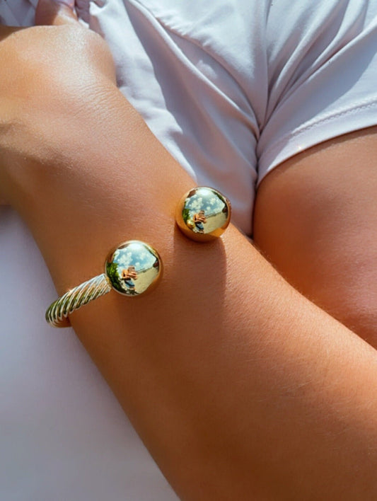 18k Gold Layered Twisted Bangle Featuring Two Solid Balls On Top Wholesale