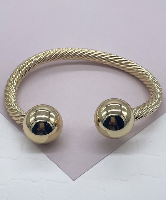 18k Gold Layered Twisted Bangle Featuring Two Solid Balls On Top Wholesale
